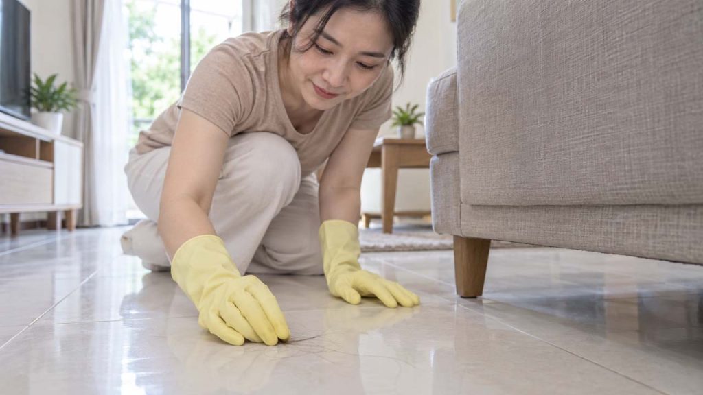 Đeo găng tay cao su để gom tóc rụng trên sàn
